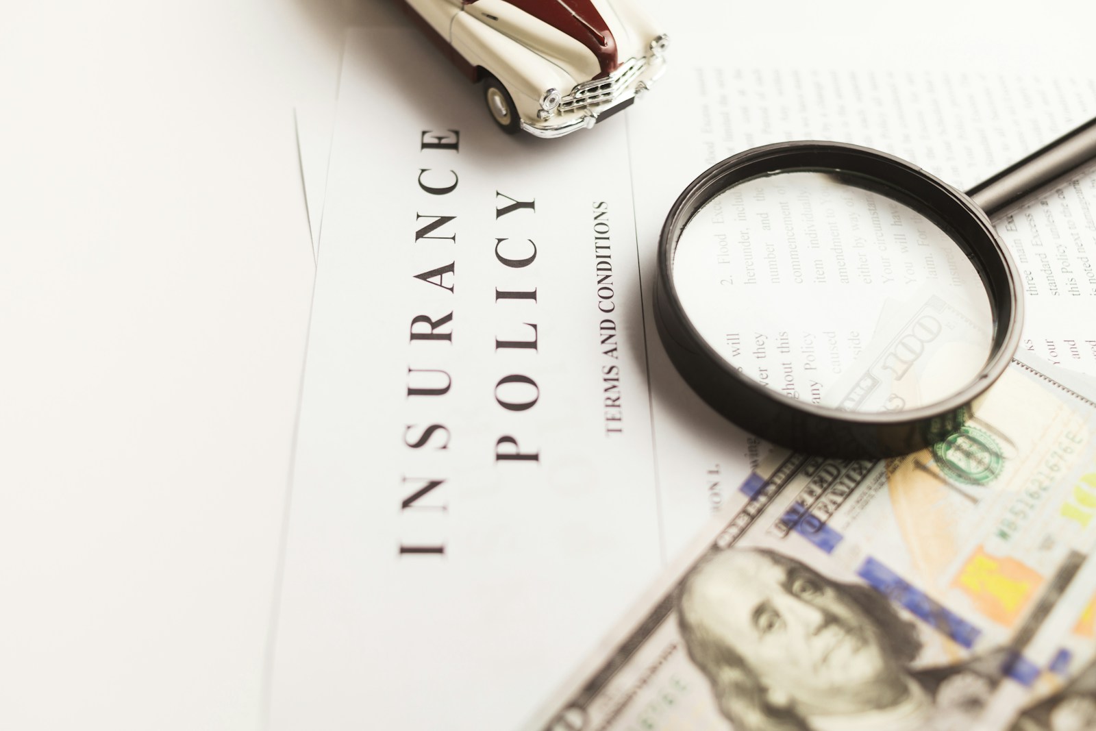 a magnifying glass sitting on top of a piece of paper symbolizing full disclosure for proper homeowners insurance coverage